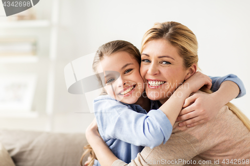 Image of happy smiling family hugging on sofa at home