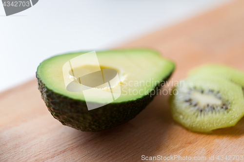 Image of close up of avocado on wooden cutting board