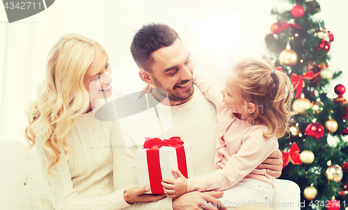 Image of happy family at home with christmas tree