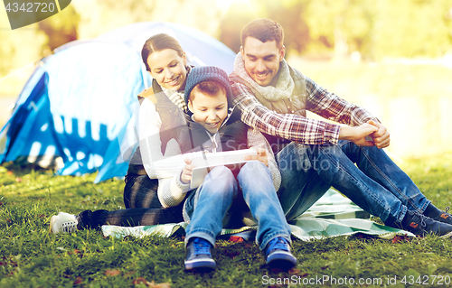 Image of happy family with tablet pc and tent at camp site