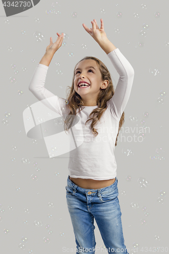 Image of Girl playing with soap bubbles