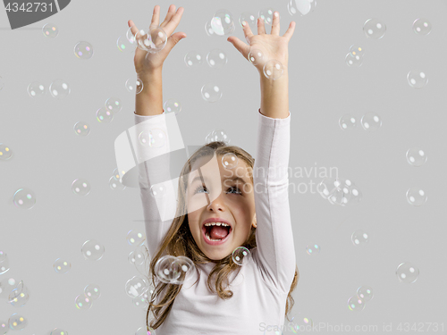 Image of Girl playing with soap bubbles