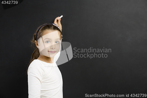 Image of Girl writing in a blackboard