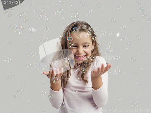 Image of Girl playing with soap bubbles