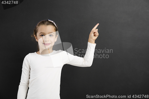 Image of Girl pointing to a blackboard