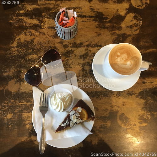 Image of Before Shot Top View of Orange Poppyseed Cake and Coffee in cafe