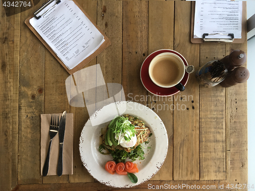 Image of Top View zucchini fritters poached eggs avocado salmon and bulle