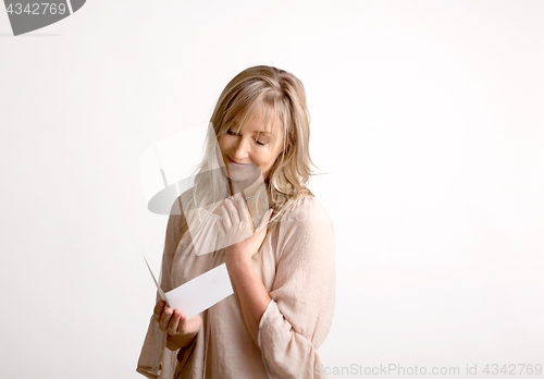 Image of Woman reading a heartfelt message note or card
