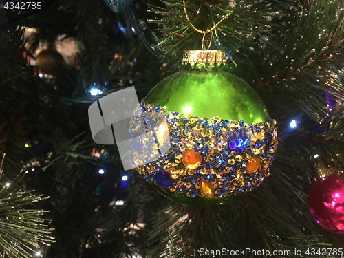 Image of Green Christmas tree bauble embellished with amber blue and gold