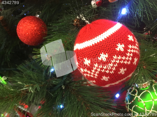 Image of Christmas tree ornaments hanging on a tree