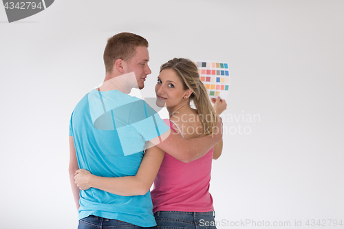 Image of couple looking at color samples at home