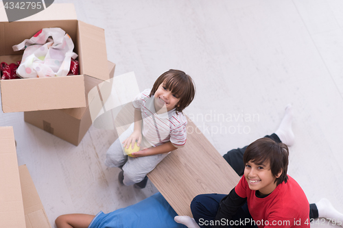 Image of boys with cardboard boxes around them top view