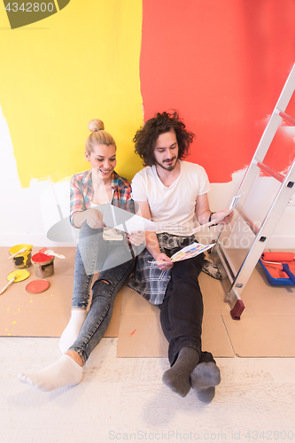 Image of Happy young couple relaxing after painting