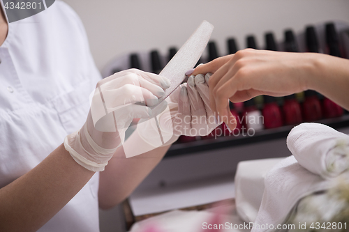 Image of Woman hands receiving a manicure