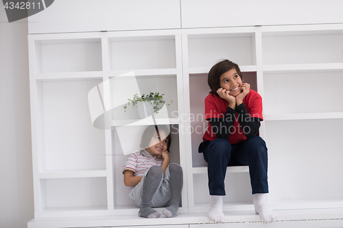 Image of young boys posing on a shelf