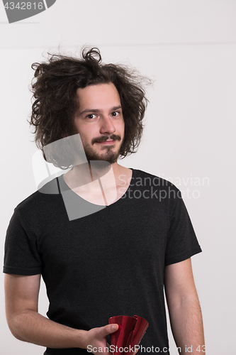 Image of Portrait of a man in party hat blowing in whistle