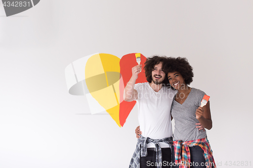 Image of couple with painted heart on wall