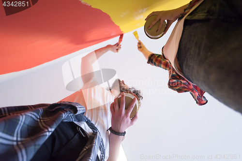 Image of couple painting interior wall