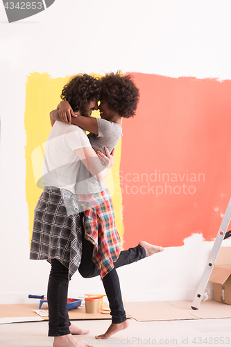 Image of Young happy multiethnic couple hugging