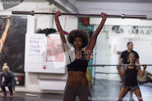 Image of black woman lifting empty bar