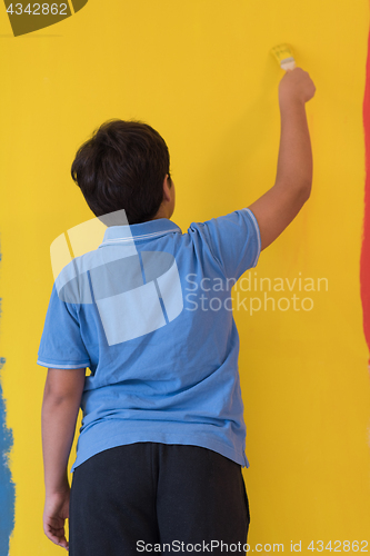 Image of Portrait of a happy young boy painter