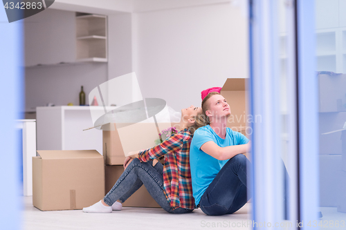 Image of young couple moving  in new house