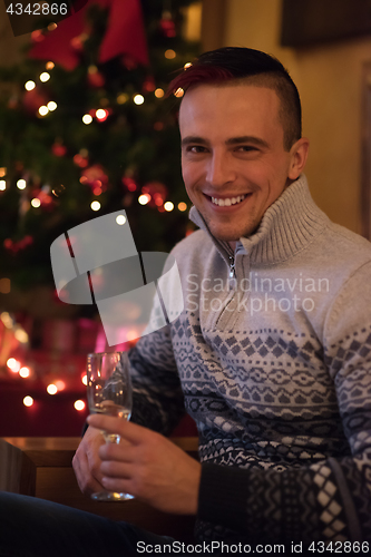 Image of Happy young man with a glass of champagne