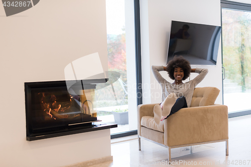 Image of black woman in front of fireplace