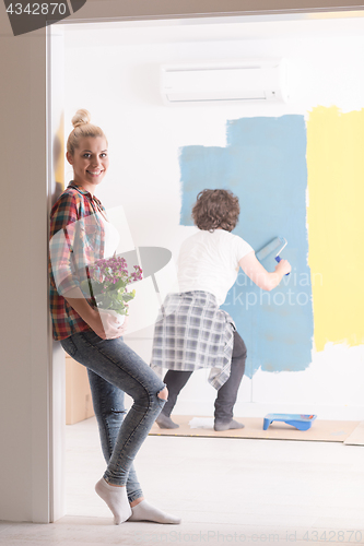 Image of happy young couple doing home renovations