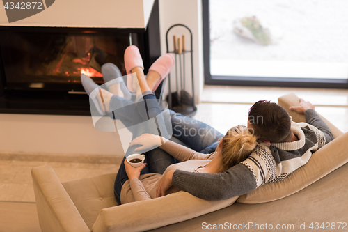 Image of Young couple  in front of fireplace
