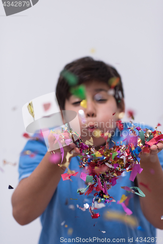 Image of kid blowing confetti