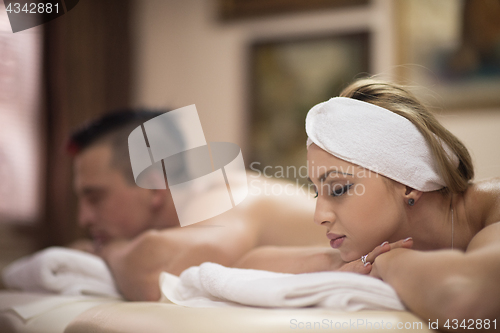 Image of young couple lying on massage table