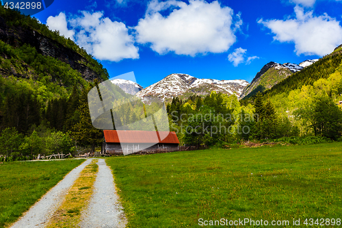 Image of Beautiful natural landscape with green meadows, snow-capped moun