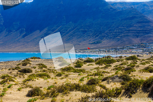 Image of Surfers beach Famara on Lanzarote always has a red flag.