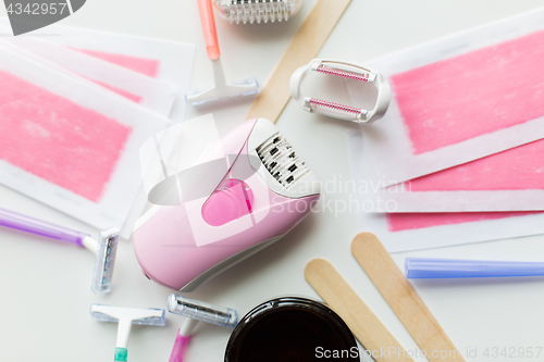 Image of hair removal wax, epilator and safety razor