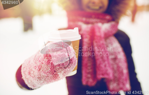 Image of close up of hand with coffee outdoors in winter