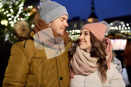 Image of happy couple hugging at christmas tree