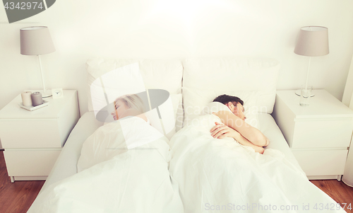 Image of couple sleeping in bed at home