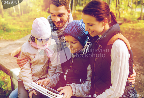 Image of happy family with tablet pc and backpacks at camp