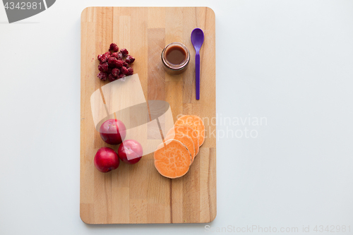 Image of fruit puree or baby food in jar and feeding spoon