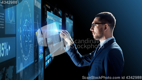 Image of businessman in glasses with virtual projection