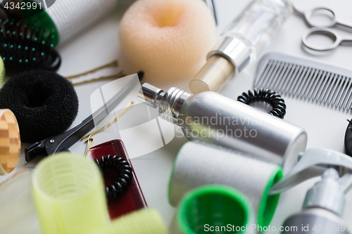 Image of hair styling sprays, curlers and pins