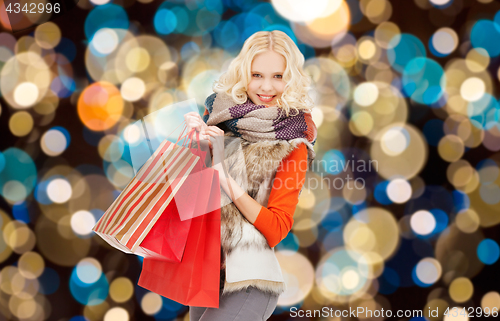 Image of young woman in winter clothes with shopping bags