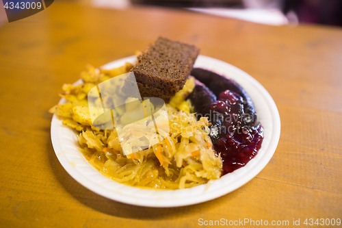 Image of braised cabbage and sausages with sauce on plate