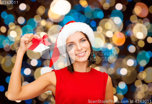 Image of happy woman in santa hat with christmas bells