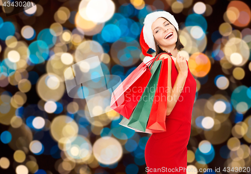 Image of woman in santa hat with christmas shopping bags