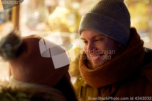 Image of close up of happy couple in winter clothes