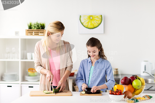 Image of happy family cooking dinner at home kitchen