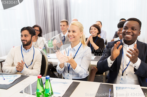 Image of people applauding at business conference