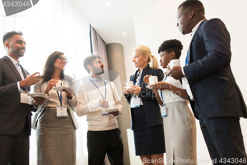 Image of business people with conference badges and coffee